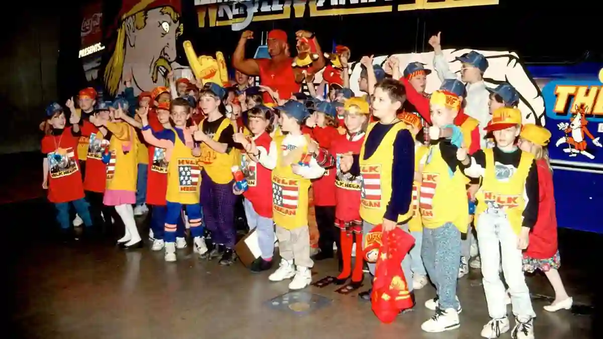 Hulk hogan picture at the set of wrestle mania with a group of kids fans.