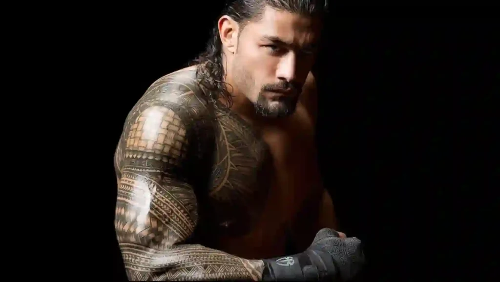 Roman Reigns displaying his Samoan tribal arm tattoo